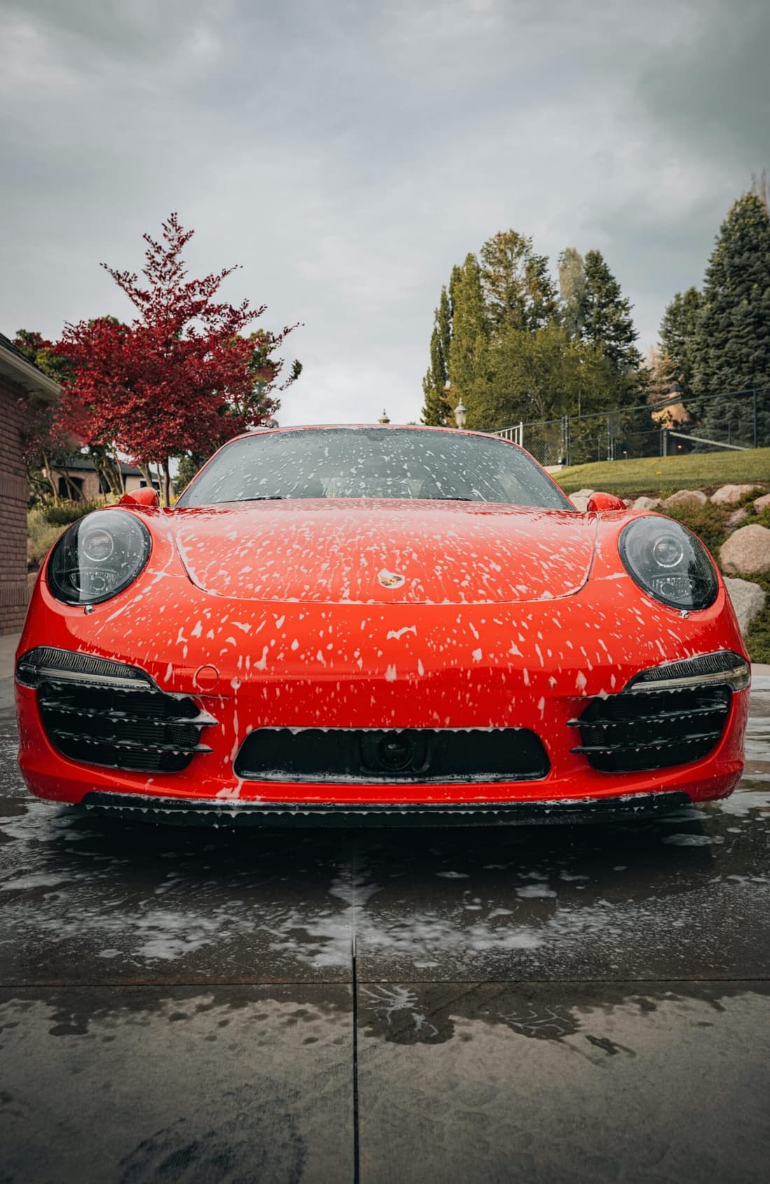 Red Porsche receiving premium mobile foam wash in West Plains MO by Premier Detailing.