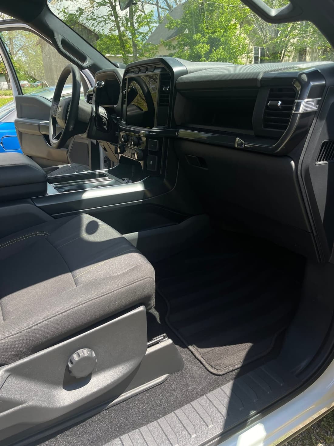 Clean and detailed interior of a pickup truck showcasing spotless dashboard, seats, and floor mats.