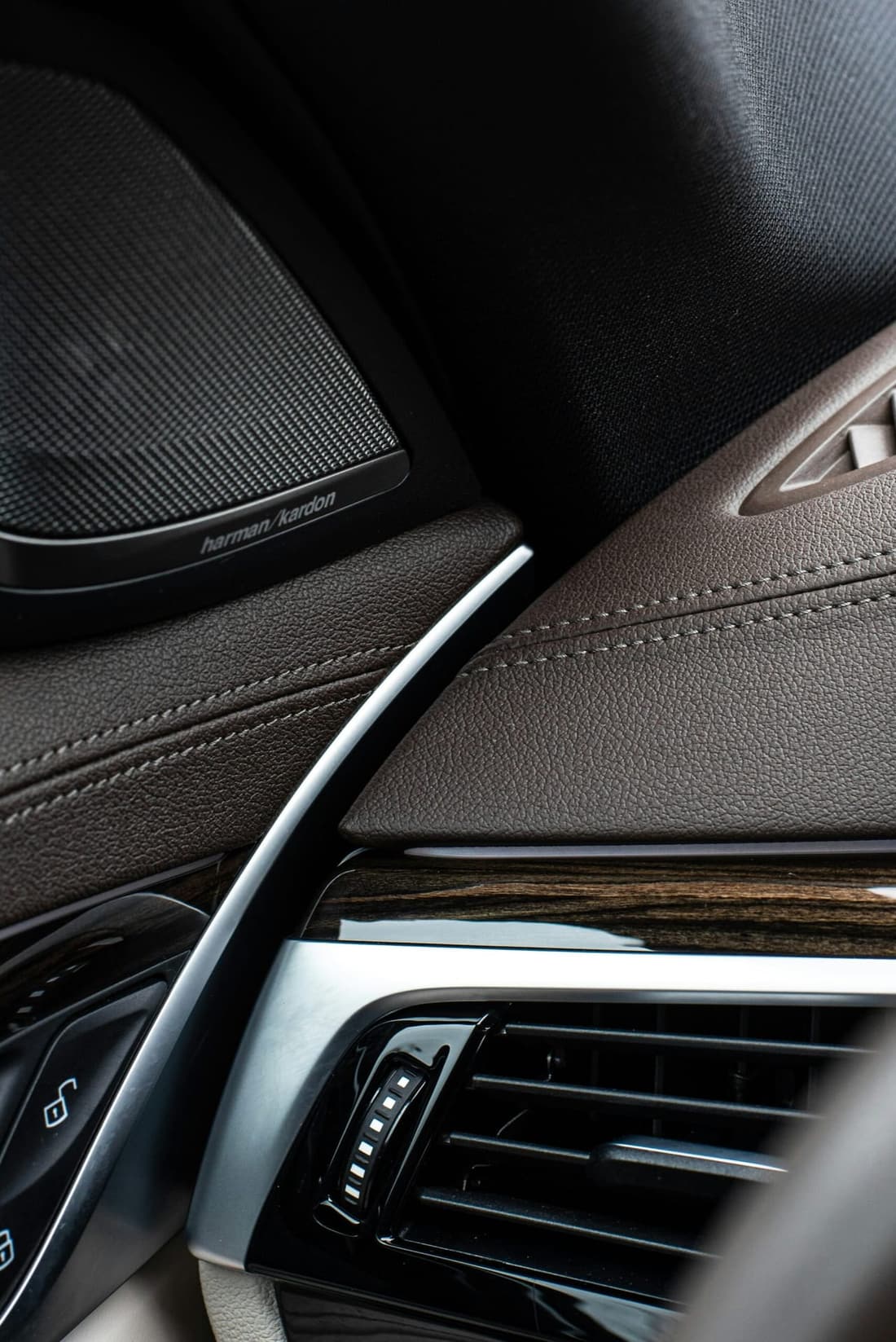 "Close-up of a car's driver-side dashboard, highlighting air vents and controls often overlooked during routine cleaning."