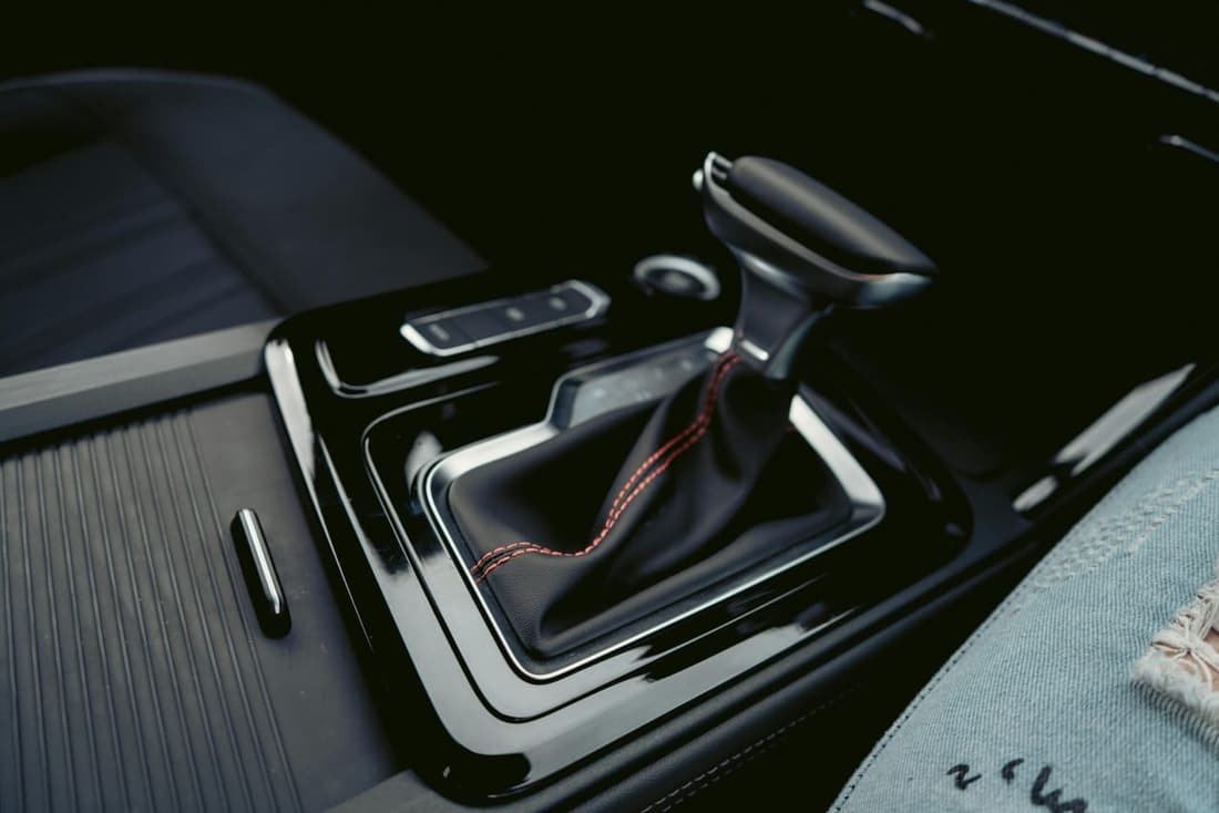 Close-up of a clean car gear shifter with red stitching after professional interior detailing in West Plains, MO