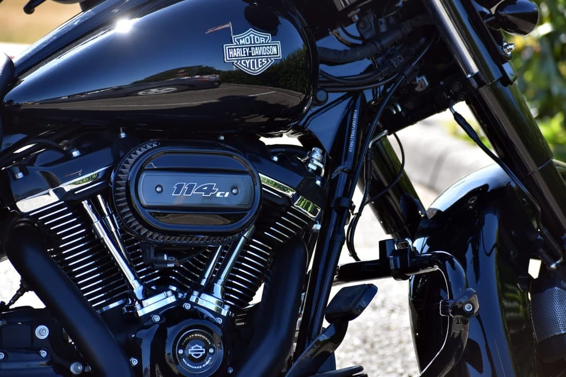 Glossy black Harley-Davidson motorcycle reflecting the spring sunlight, freshly detailed and polished for the riding season.