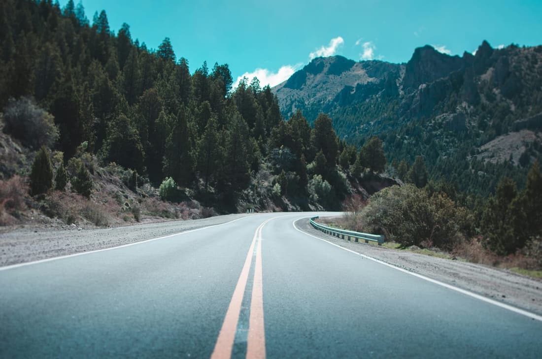 "Scenic road view captured during a road trip, showcasing a spotless vehicle after a professional detail by Premier Detailing. The clean windows and polished exterior highlight the benefits of expert care for a safe and enjoyable journey."