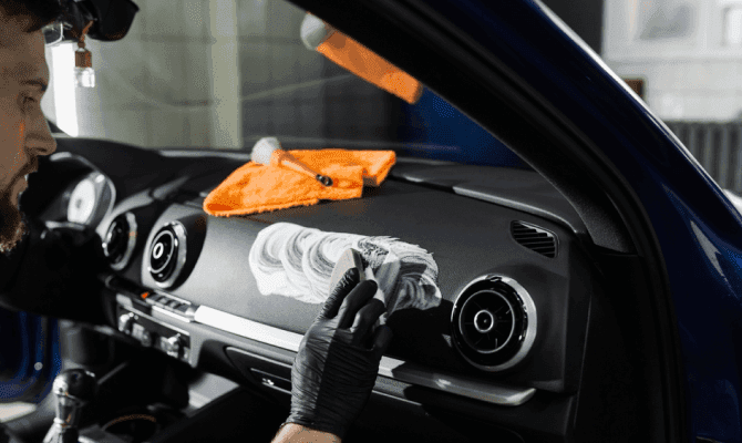 Close-up of passenger side dashboard being cleaned with a detailing brush during professional mobile detailing in West Plains, MO
