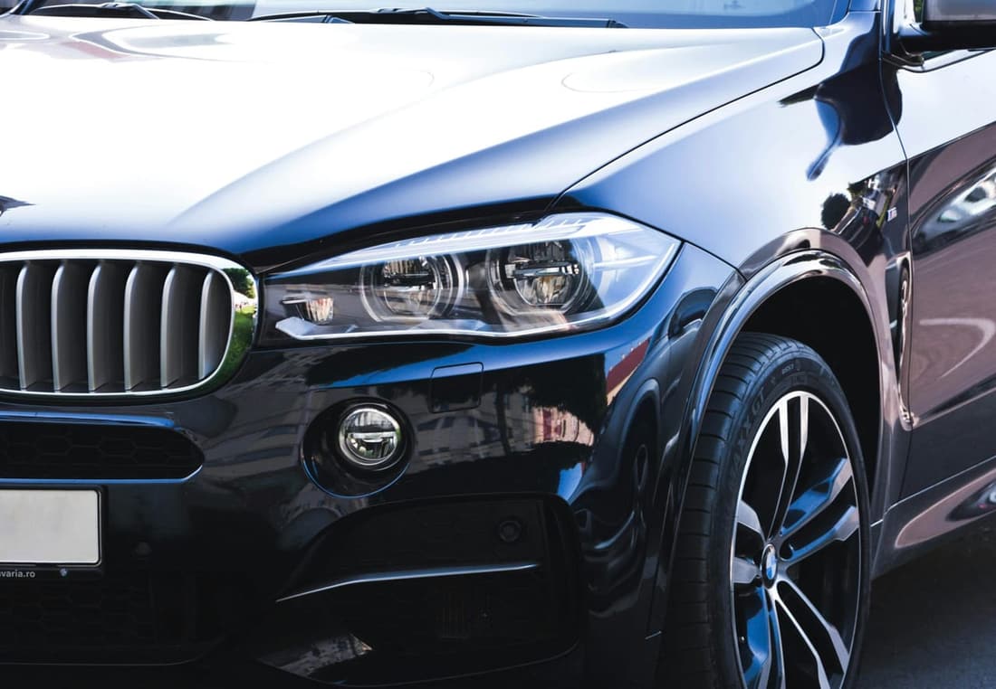 Close-up of a clean luxury SUV front end after professional detailing