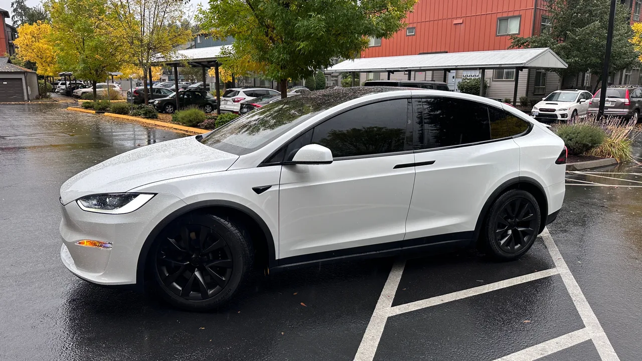 White Tesla Model X with dark ceramic window tint in a parking lot — window tinting in West Plains, MO